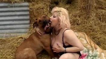 Big-boobed MILF and trained beagle are fucking in the hayloft