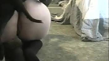 Plump-bottomed older woman enjoys oral pleasure with a canine
