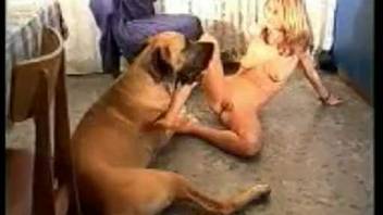 Rough anal intercourse scene featuring a blonde woman and her dog
